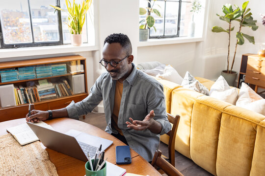 Man on a conference call from home office