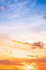 Sunset or sunrise sky with a vibrant gradient of orange, gold, and soft blue. Clear atmosphere with wispy clouds. Peaceful, natural light background. hope, freedom, new day and inspirational Concepts