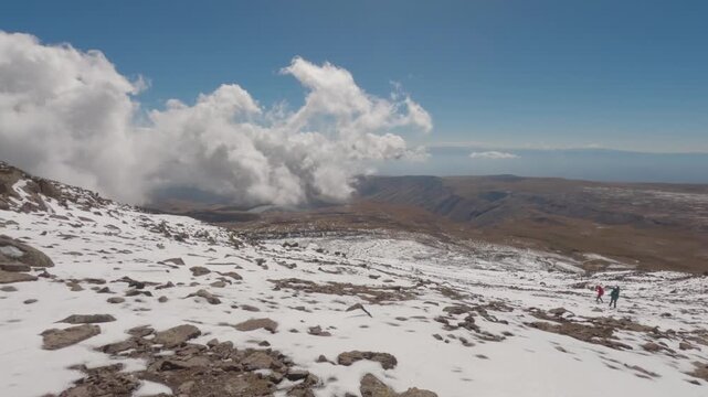 Tourists walk down from the summit of Mount Aragats, South summit in Armenia.