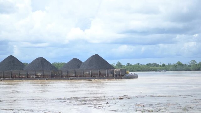 Tideng Pale - Indonesia, 22 November 2025 : coal transport pontoon across the river