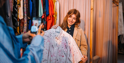 A Fashion Enthusiast Trying On a Vintage Shirt in a Vibrant Clothing Store Setting