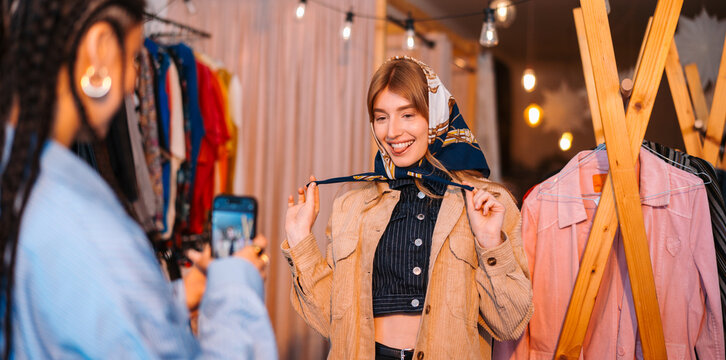 Trendy Friends Enjoying a Fun Photo Session in a Boutique Style Clothing Store