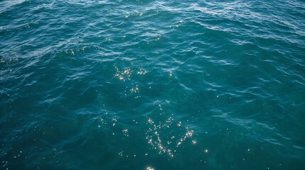 Obraz premium A close-up shot of the crystal-clear ocean surface, with sparkling sun reflections dancing on the water