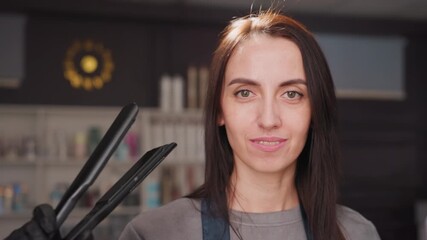 stylist styling hair, closeup of stylist demonstrating controlled heat styling process, expert hairdresser illustrating meticulous iron technique with attention to detail and safety