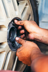 Vertical Mechanic man hands repairing car shop. Man hands fixing Car machinery vehicle mechanical service. Vertical horizon vehicle hood checking automobile. Car motor Workshop oil garage maintenance