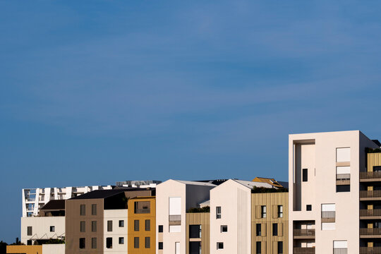 Architectural geometry and minimalism meet on a facade where contrast, sunlight, and precise lines convey modern housing values supported by a clean design and balanced urban style