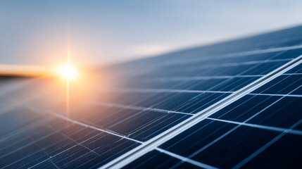 A solar panel with the sun setting in the background, creating a lens flare effect