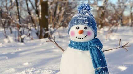 Snowman wearing blue knitted hat and scarf in a sunny winter landscape