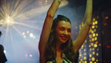Fototapeta premium Carefree girl dancing club illuminated neon lights closeup. Smiling woman moving
