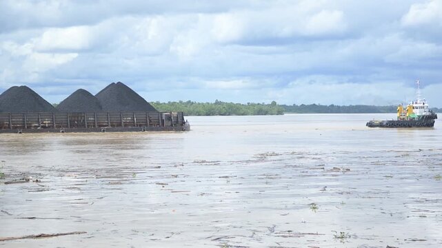 Tideng Pale - Indonesia, 22 November 2025 : coal transport pontoon across the river