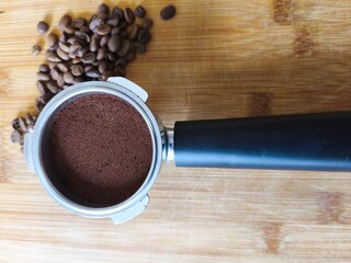Fresh Ground Coffee in Portafilter on Wooden Surface