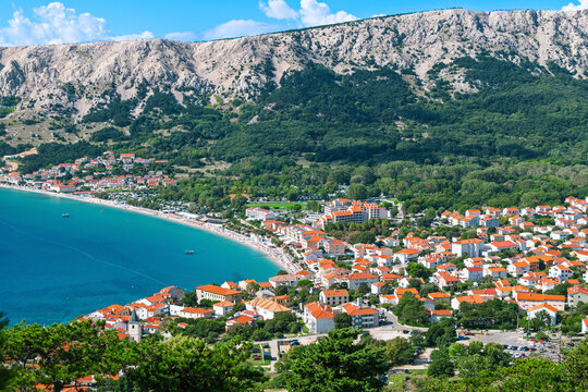 Picturesque aerial view of coastal town with vibrant rooftops and turquoise sea. Baška, Krk island, Croatia - Powered by Adobe