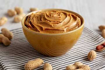 Creamy Brown Peanut Butter in a Bowl, low angle view. Close-up.