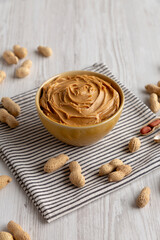 Creamy Brown Peanut Butter in a Bowl, low angle view. Close-up.