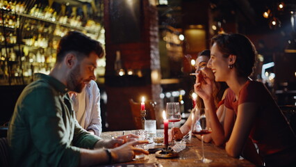 Relaxed people smoking bar enjoying night gathering closeup. Happy friends bar