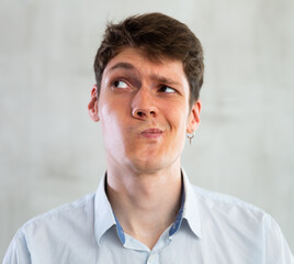 Obraz premium Emotions, people and positive concept man expresses different on gray background