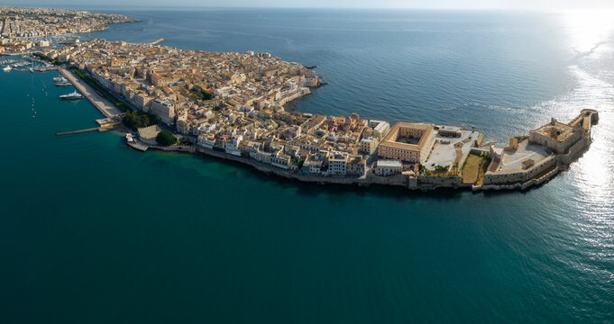 Panoramic aerial view of the island of Ortygia. This is the location of the historic center of Syracuse, Sicily, Italy. The city overlooks the Mediterranean Sea and contains many historical landmarks.