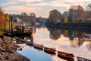 Beautiful view of rowboats moored in line on the River Thames on a cold day in late autumn, early...