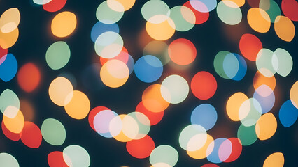 Festive multicolored bokeh background texture of shimmering holiday lights on a dark night.
