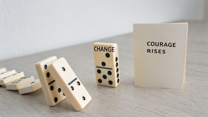 Upright domino with CHANGE title about to fall in studio light