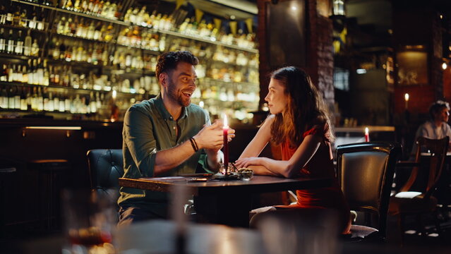 Loving pair talking bar enjoy cozy romantic atmosphere. Smiling romantic couple