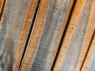 Close-up of natural wooden planks showing texture, grain lines and warm brown tones