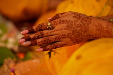 Bengali bride&rsquo;s mehendi hands during wedding ritual