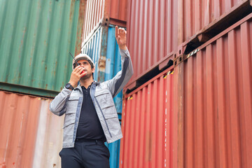 Foreman in Hard Hat Communicating on Walkie-Talkie in Container Shipping Yard, Port Worker Directing Operations, Engineer Giving Instructions via Two-Way Radio