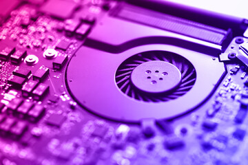 Closeup on cooler of laptop. Neon tone image