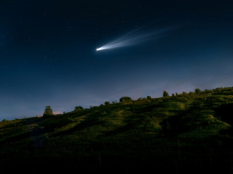 Comet in the sky visible to the naked eye. Bright tail of a comet over a hill. Astronomical observation of a space object.