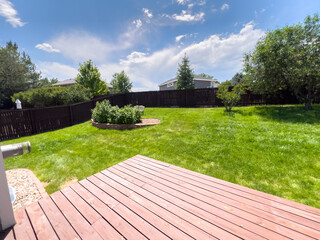 Suburban backyard with red deck and garden