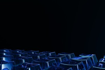 translucent blue geometric shapes, resembling abstract keyboard keys, brightly illuminated against a dark, featureless background
