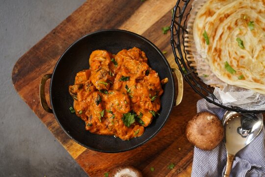Homemade Mushroom tikka masala served with malabar porotta, selective focus
