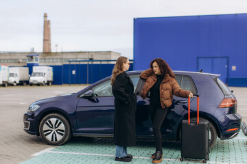 Two women discussing before starting a journey