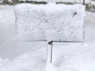 Snow covered signboard in deep winter snow outdoors