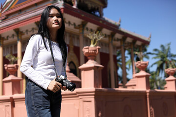 Asian Woman Photographer Exploring Traditional Temple Outdoors