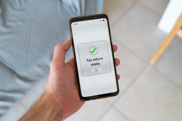 Tax return ready message on phone screen. Doing your taxes with phone app.