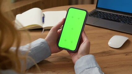 Woman use digital tech cell phone open green screen mock up. Hand press click phone web site middle center. Girl hold mobile. Turn on chroma key page. Cozy home background. Online app copy space.