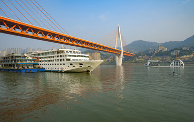 Luxury cruise ships sailing on the Yangtze River, the city skyline in Chongqing, China