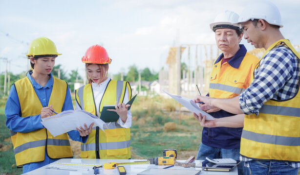 Male and female engineers who are Asian professionals in the construction industry focus on village design and architecture to create sustainable houses for people to rent and sell.