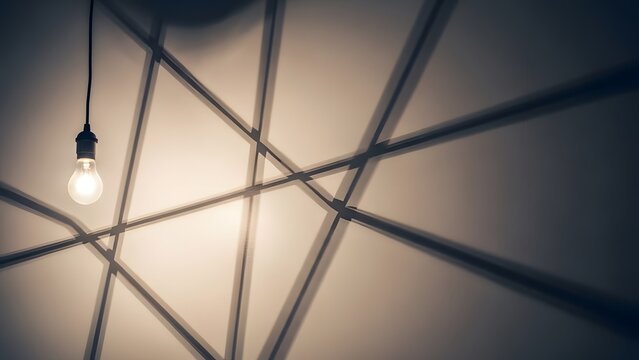 Single lightbulb casting a geometric shadow, modern minimalism.