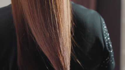 caucasian professional stylist at work, stylish caucasian barber delicately handling hair tip carefully, skilled hairdresser in modern salon focusing on precise hair cutting technique