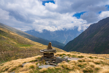 View en route to Rupin pass trekking trail near the viewpoint of  sacred Kinner Kailash peak. It is a high altitude trek in Himachal Pradesh with Himalayan ranges, glacial meadows.