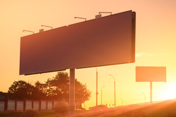 Background for design. Advertising billboard along the road in the city on a sunny evening