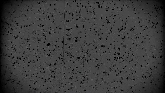 Abstract black and gray speckled background with dark vignette edges and scratch marks
