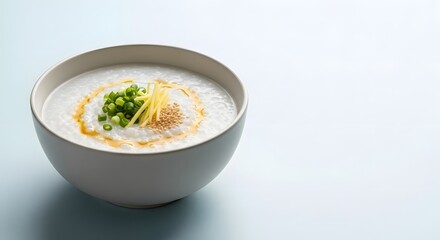 Congee or Rice Porridge Bowl with Scallions, Ginger, and Sesame Seeds