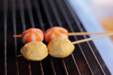 Thai-Asian style barbecue meatballs called 'Mala' served with a rich chili sauce, sold as street food.
