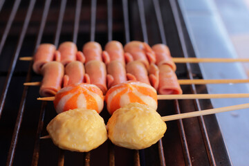 Thai-Asian style barbecue meatballs called 'Mala' served with a rich chili sauce, sold as street food.