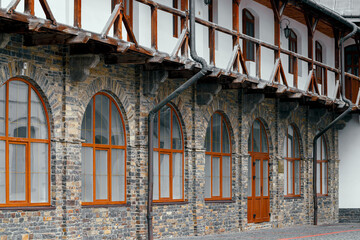 medieval European aesthetic architecture monastery campus old stone facade with arch windows perspective background space