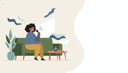 Happy woman recording a podcast or singing into a microphone on a cozy sofa at home